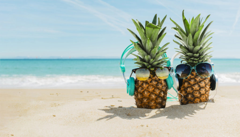 beach-background-with-cool-pineapples-wearing-headphones_23-2147836098